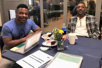 Offender and his dad with a laptop at the LaunchCode graduation
